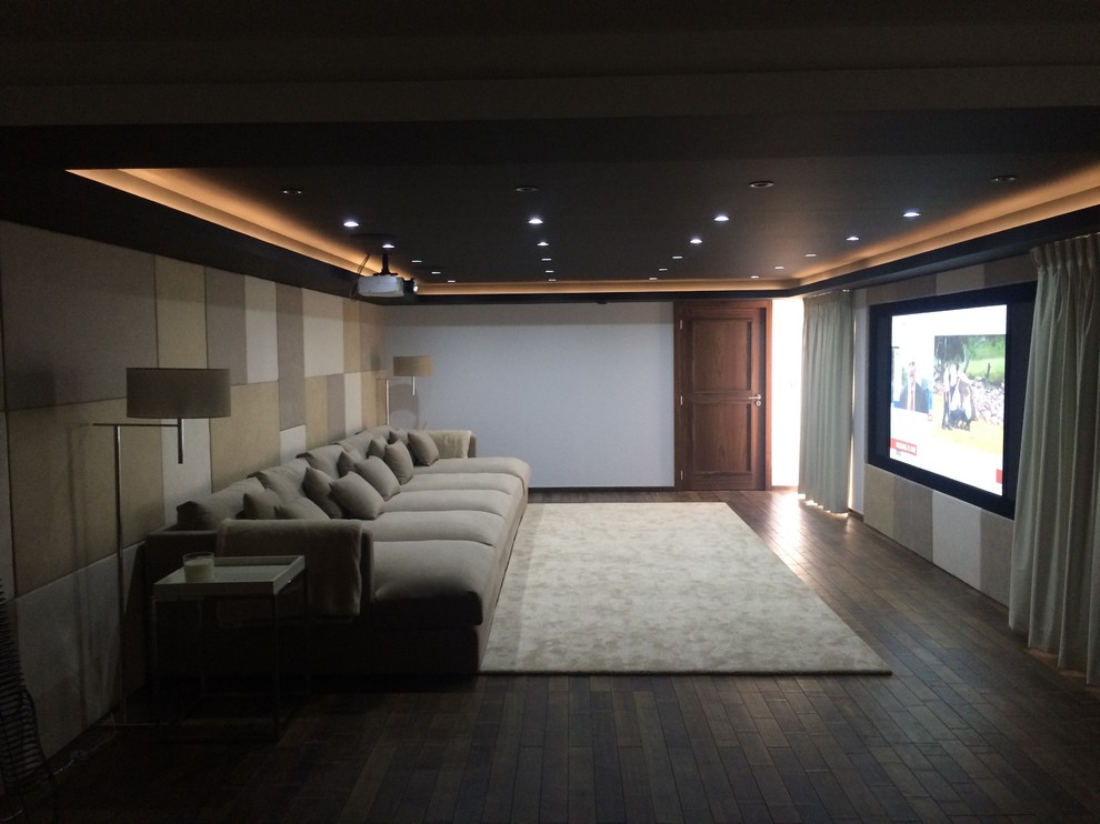 This is an example of a large contemporary home theatre in Other with bamboo floors and a projector screen.