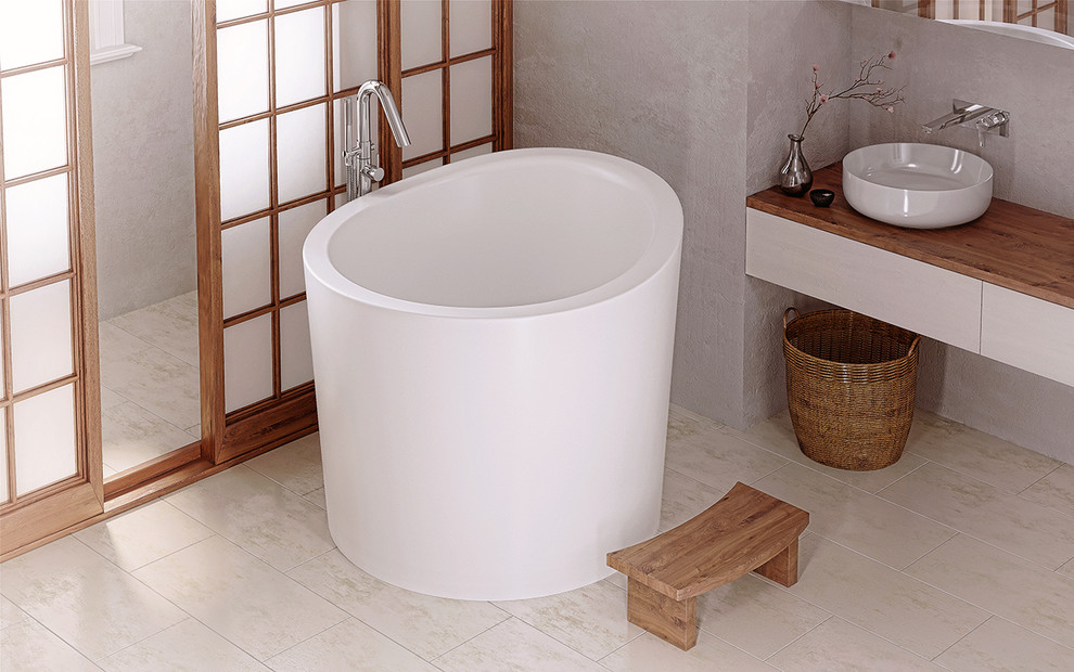 This is an example of a small asian bathroom with a japanese tub, beige walls and porcelain floors.
