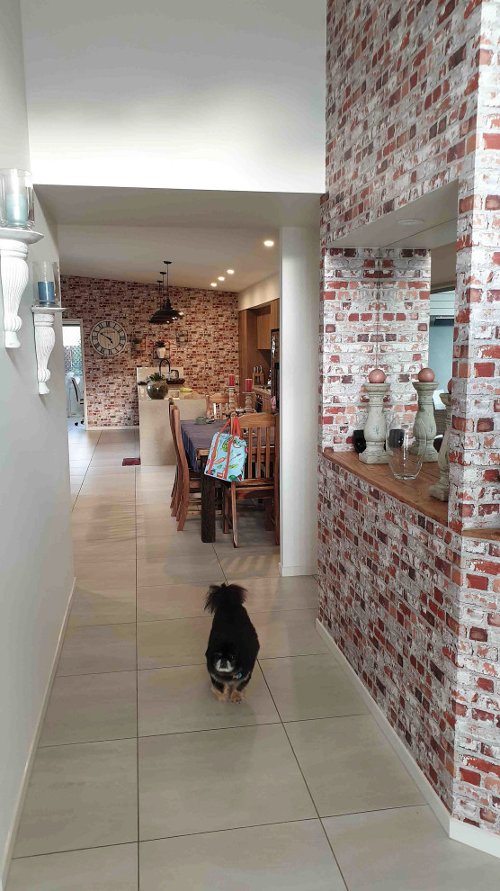Design ideas for a mid-sized contemporary hallway in Sunshine Coast with beige walls, porcelain floors and beige floor.