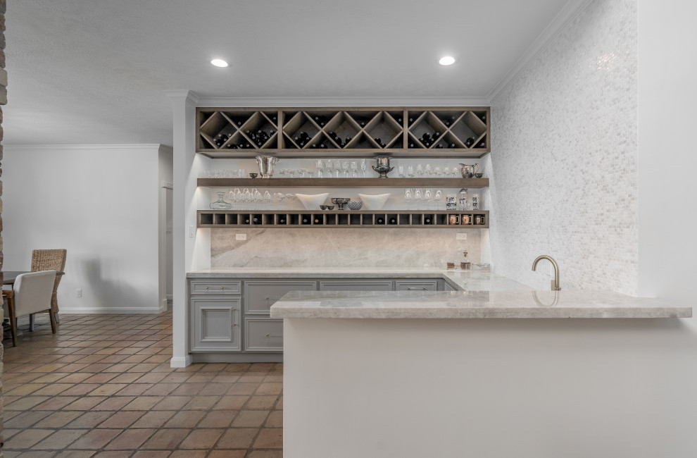 Inspiration for a mid-sized traditional u-shaped wet bar in Houston with an undermount sink, recessed-panel cabinets, grey cabinets, granite benchtops, multi-coloured splashback, granite splashback and multi-coloured benchtop.