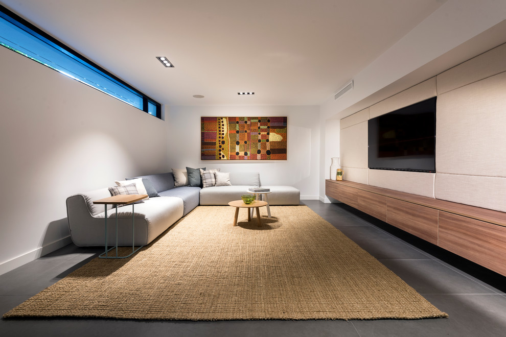 Inspiration for a large modern look-out basement in Perth with porcelain floors and grey floor.