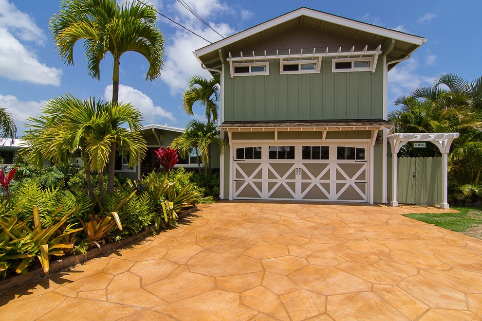 Photo of a mid-sized tropical one-storey green house exterior in Hawaii with wood siding and a gable roof.