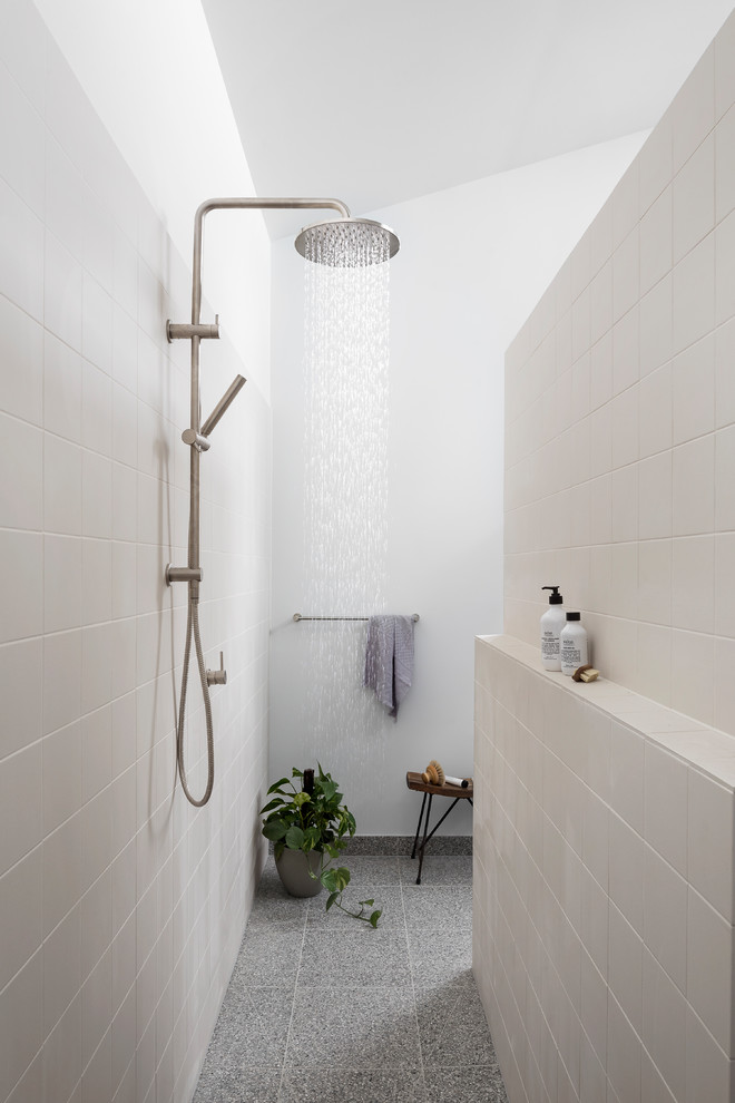 Large contemporary bathroom in Melbourne with terrazzo floors, an open shower, a curbless shower, beige tile, white walls and grey floor.