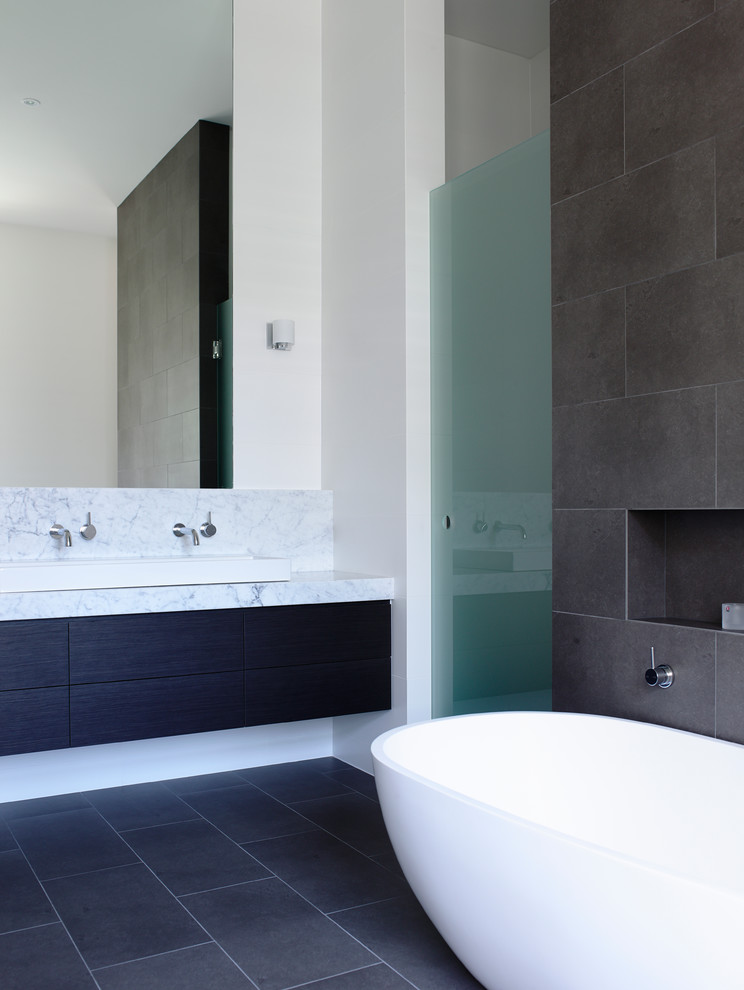 Mid-sized contemporary bathroom in Melbourne with marble benchtops and a freestanding tub.