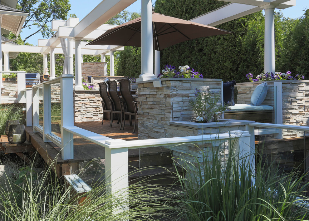 Outdoor kitchen deck - huge transitional backyard outdoor kitchen deck idea in Chicago with a pergola
