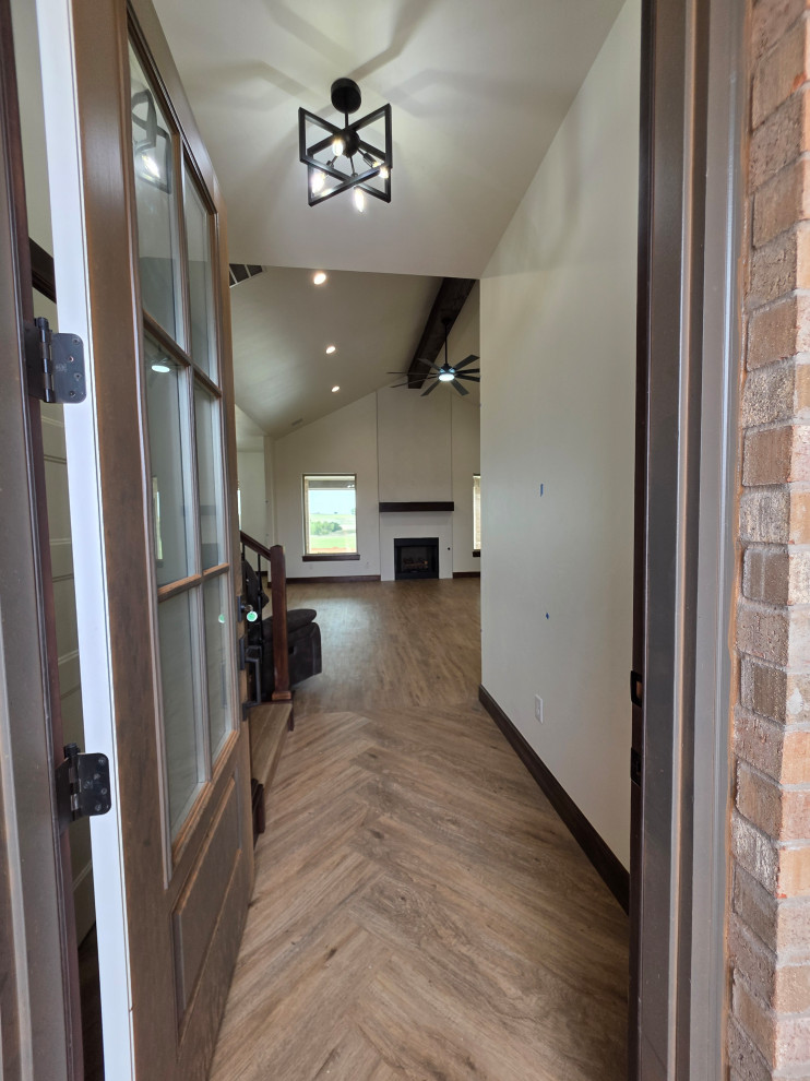 Entryway to home with herringbone patterned floors