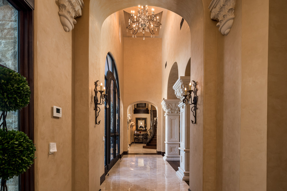 This is an example of an expansive country hallway in Phoenix with grey walls, marble floors and multi-coloured floor.