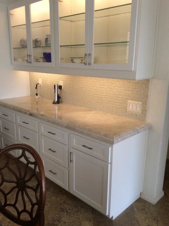 Inspiration for a mid-sized transitional l-shaped travertine floor and brown floor eat-in kitchen remodel in Orange County with white cabinets, mosaic tile backsplash, shaker cabinets, marble countertops, beige backsplash, stainless steel appliances and an island