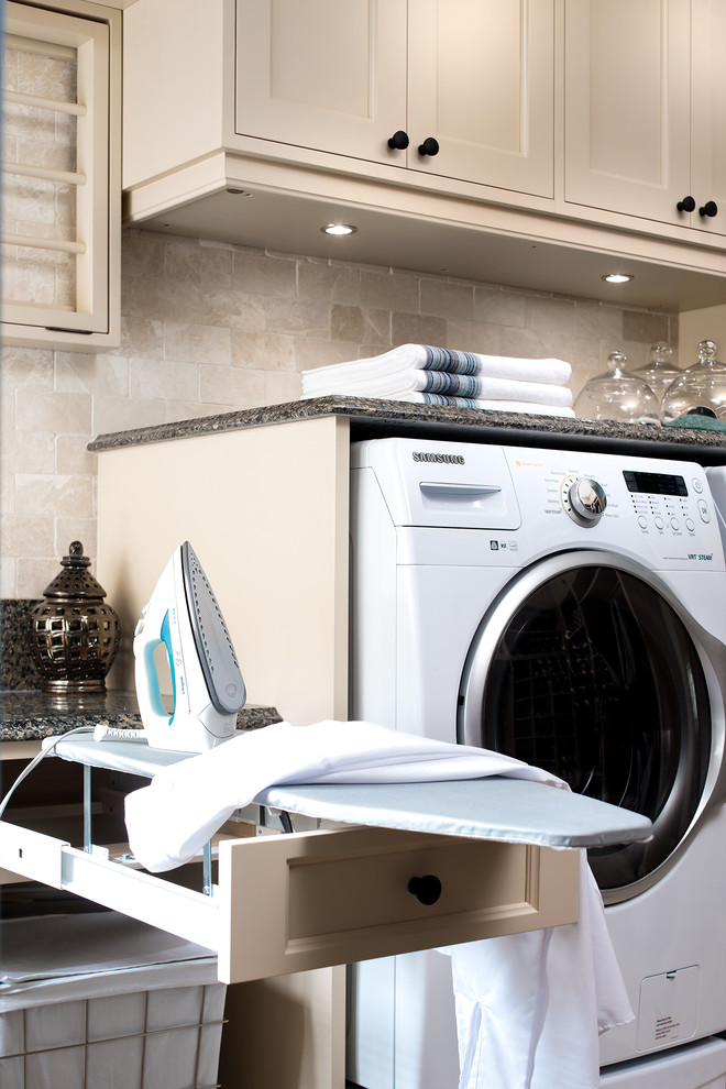 This is an example of a large traditional utility room in Toronto with beige cabinets and a side-by-side washer and dryer.