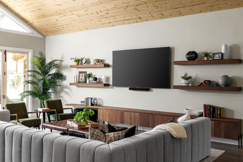 This is an example of a large retro open plan living room in Dallas with grey walls, medium hardwood flooring, no fireplace, a wall mounted tv and a wood ceiling.