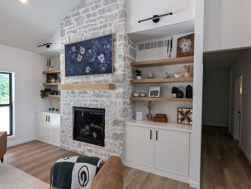 Large transitional l-shaped vinyl floor and brown floor eat-in kitchen photo with a double-bowl sink, shaker cabinets, light wood cabinets, quartzite countertops, white backsplash, ceramic backsplash, stainless steel appliances, an island and white countertops