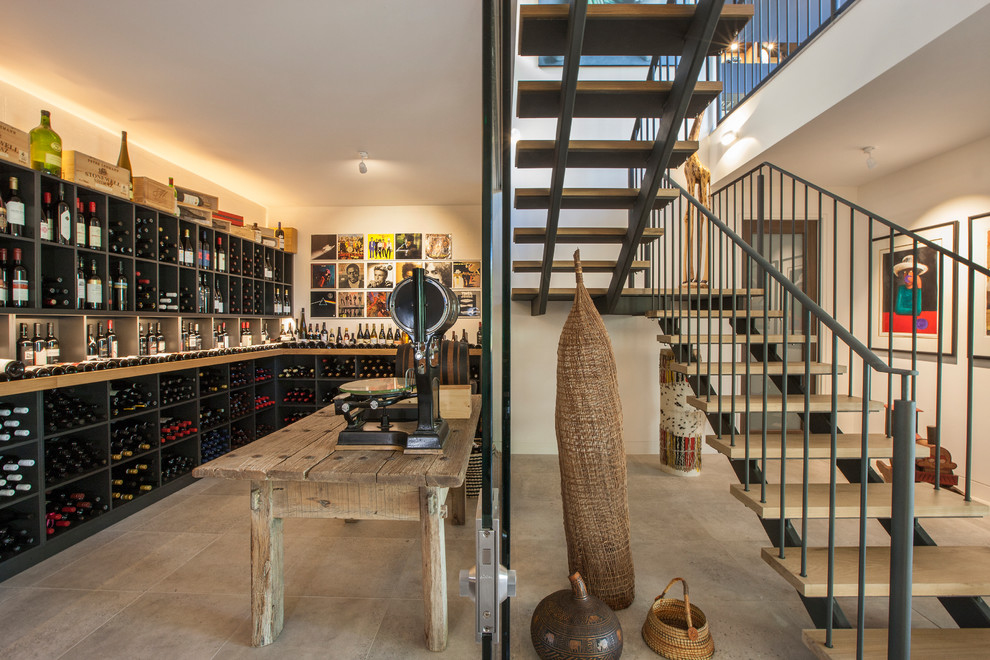 This is an example of a large contemporary wine cellar in Adelaide with ceramic floors and display racks.