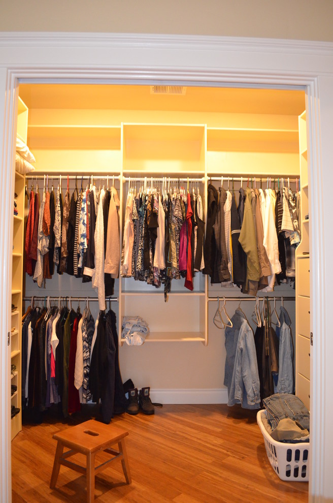 Design ideas for a large traditional walk-in wardrobe in Other with bamboo floors.
