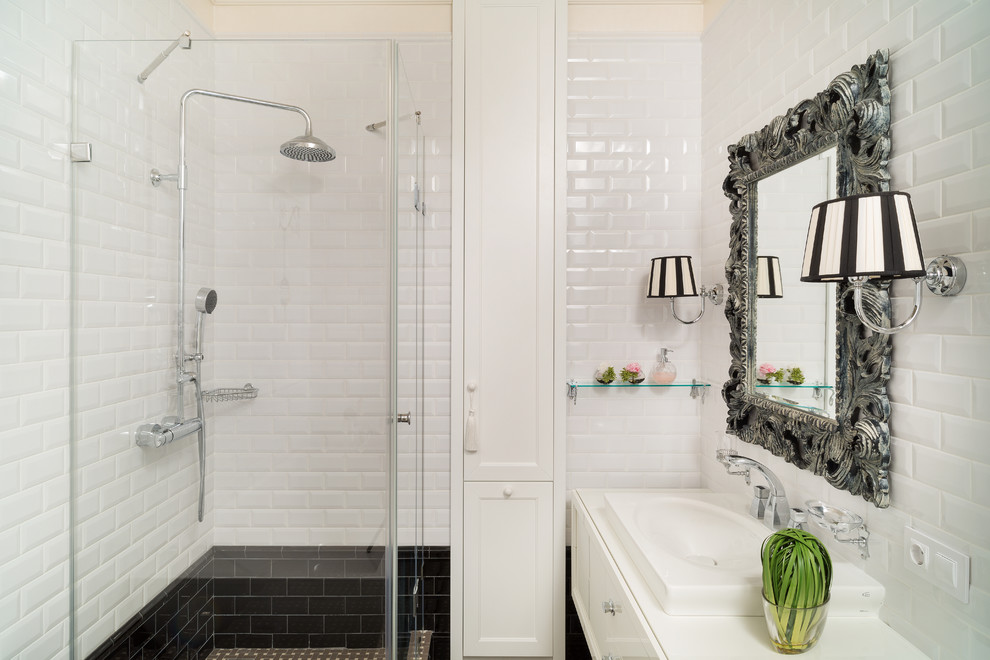 Inspiration for a traditional 3/4 bathroom in Moscow with white tile, subway tile, flat-panel cabinets, white cabinets, a corner shower, a drop-in sink and a hinged shower door.