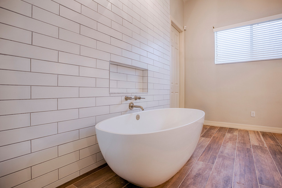 Example of a huge transitional master brown tile and porcelain tile porcelain tile freestanding bathtub design in Phoenix with shaker cabinets, white cabinets, a two-piece toilet, gray walls, an undermount sink and quartzite countertops