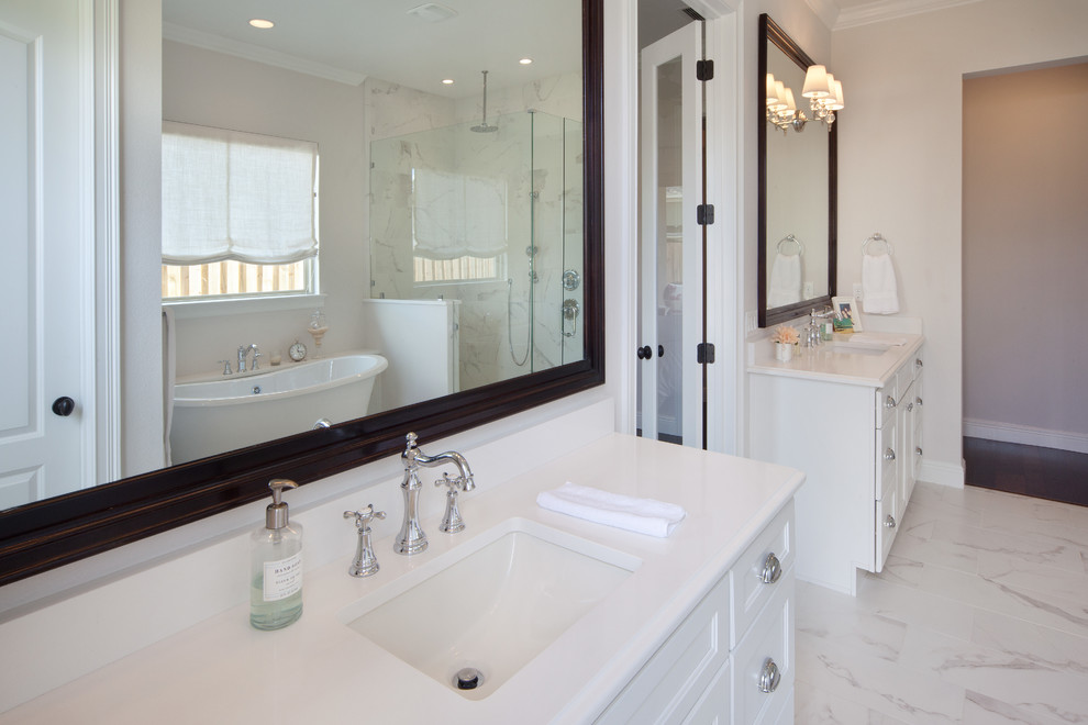 This is an example of a large transitional bathroom in Orlando with an undermount sink, flat-panel cabinets, white cabinets, quartzite benchtops, a claw-foot tub, a corner shower, a one-piece toilet, white tile, porcelain tile, grey walls and porcelain floors.