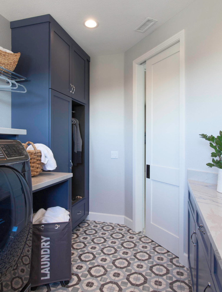 Ispirazione per una sala lavanderia minimalista di medie dimensioni con ante lisce, ante blu, pareti bianche, pavimento con piastrelle in ceramica e pavimento multicolore
