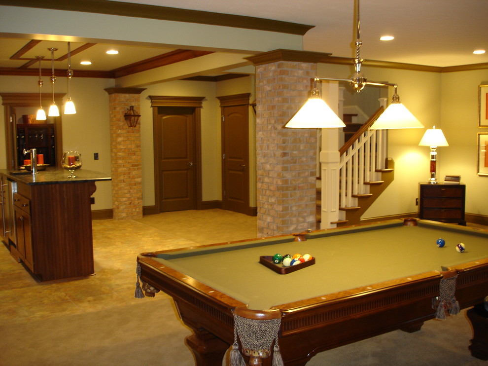 This is an example of an expansive traditional walk-out basement in Indianapolis with grey walls and carpet.