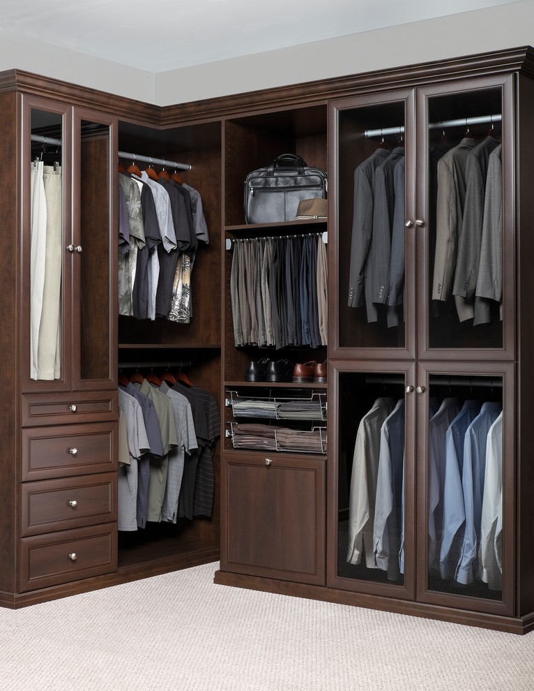 Design ideas for a mid-sized transitional men's walk-in wardrobe in Phoenix with raised-panel cabinets, dark wood cabinets and carpet.