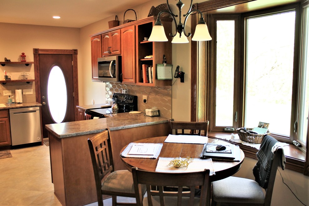 Inspiration for a mid-sized rustic l-shaped vinyl floor and beige floor eat-in kitchen remodel with a farmhouse sink, raised-panel cabinets, medium tone wood cabinets, laminate countertops, beige backsplash, cement tile backsplash, stainless steel appliances, a peninsula and beige countertops