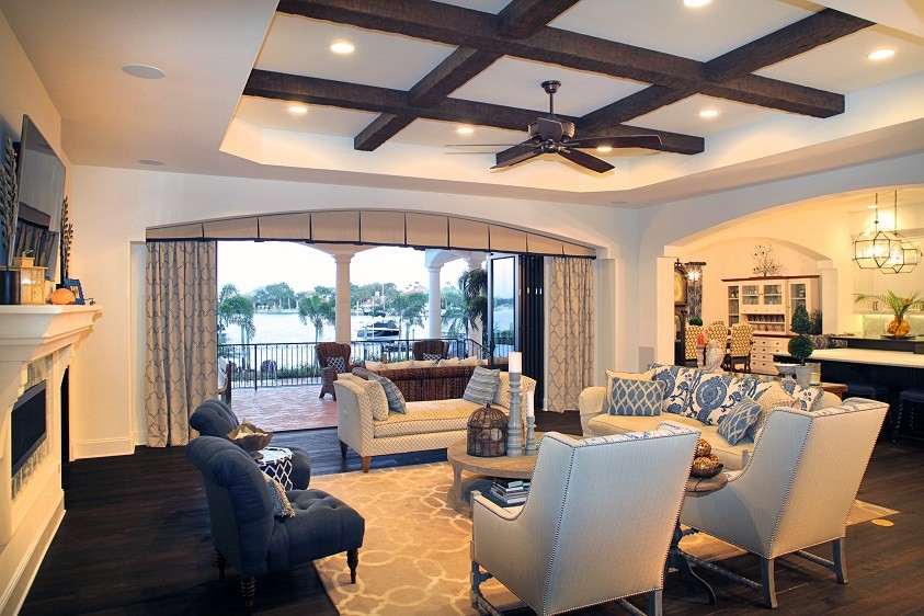 Inspiration for a large mediterranean open concept family room in Tampa with white walls, dark hardwood floors, a tile fireplace surround, a wall-mounted tv and a ribbon fireplace.