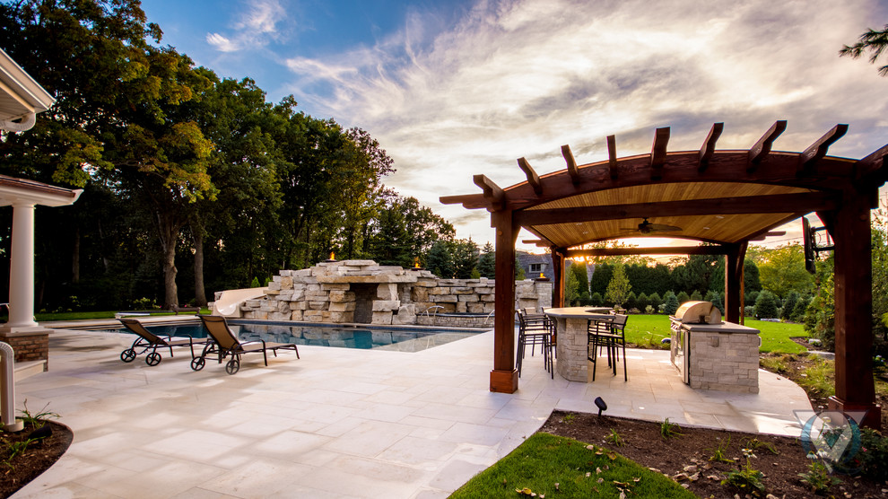 Example of a large mountain style backyard stone and rectangular natural pool fountain design in Chicago