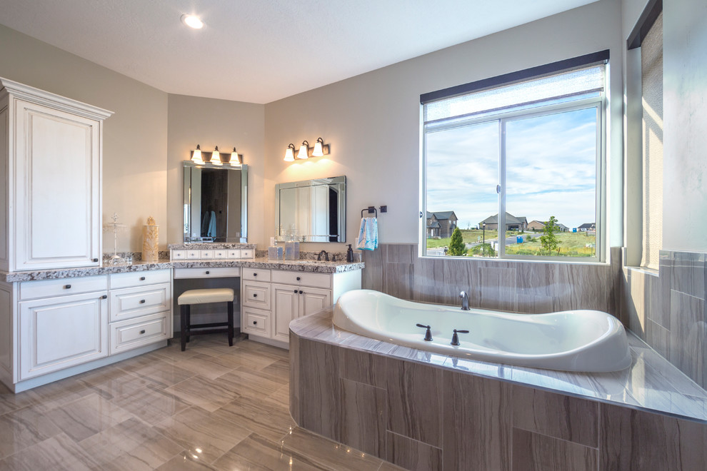 Inspiration for a large arts and crafts master bathroom in Salt Lake City with an undermount sink, raised-panel cabinets, white cabinets, granite benchtops, a corner tub, a curbless shower, gray tile, ceramic tile, grey walls and ceramic floors.