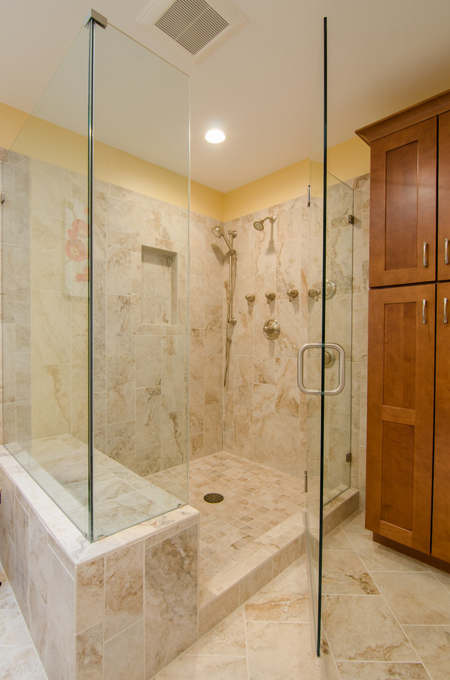 This is an example of a large contemporary master bathroom in DC Metro with recessed-panel cabinets, medium wood cabinets, granite benchtops, beige tile, porcelain tile, a double shower, an undermount sink, yellow walls and porcelain floors.
