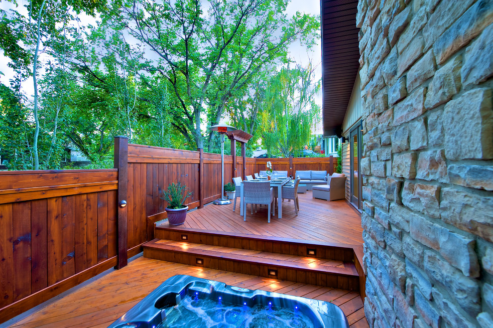 Inspiration for a small traditional backyard deck in Calgary with a water feature.