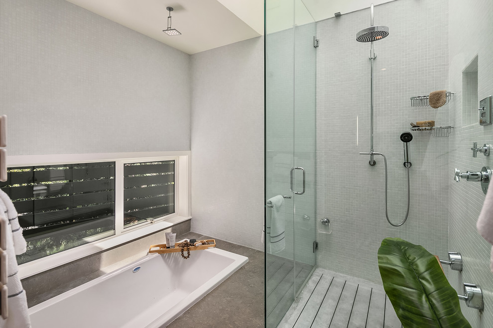 Design ideas for an expansive beach style master bathroom in Seattle with furniture-like cabinets, orange cabinets, a drop-in tub, a curbless shower, white walls, a vessel sink, grey floor and a hinged shower door.