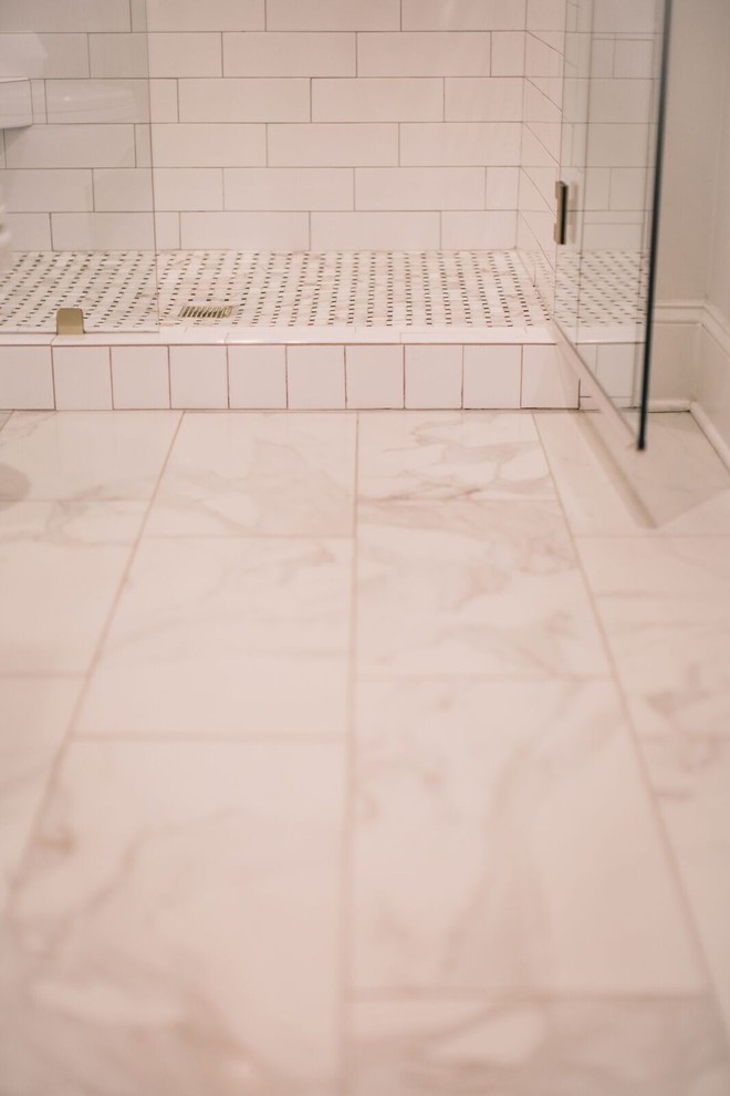 Inspiration for a mid-sized traditional 3/4 bathroom in Birmingham with an alcove shower, white tile, porcelain tile, porcelain floors, raised-panel cabinets, dark wood cabinets, a one-piece toilet, white walls, an undermount sink and soapstone benchtops.