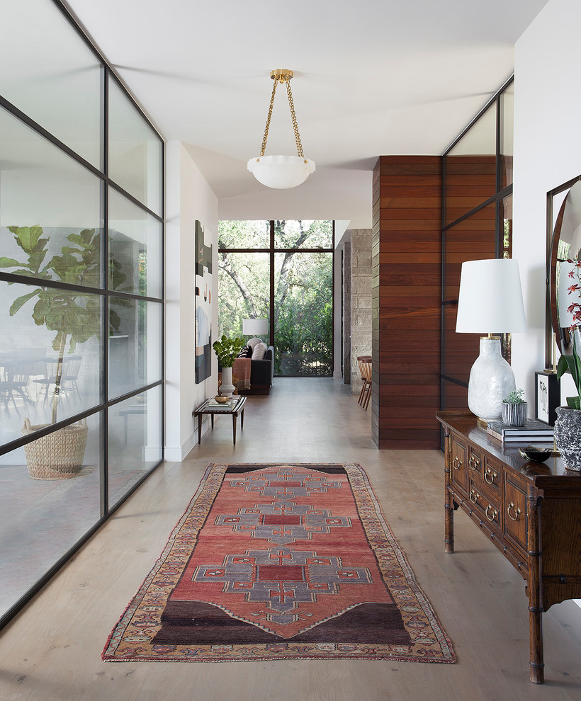 Inspiration for a contemporary light wood floor and beige floor entry hall remodel in Austin with white walls