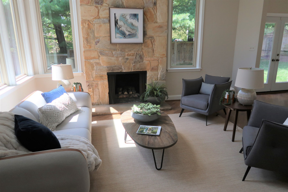 Mid-sized contemporary open concept living room in DC Metro with white walls, dark hardwood floors, a standard fireplace and a stone fireplace surround.
