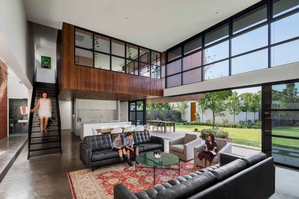 Photo of a contemporary open concept living room in Other with concrete floors.