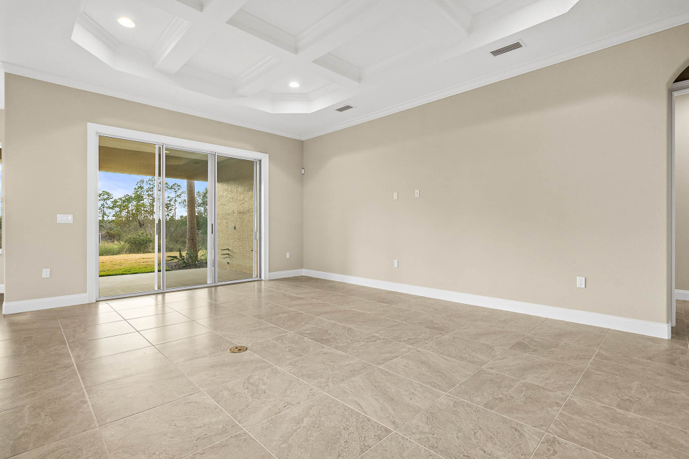 This is an example of a large transitional open concept living room in Orlando with beige walls, ceramic floors, beige floor and coffered.