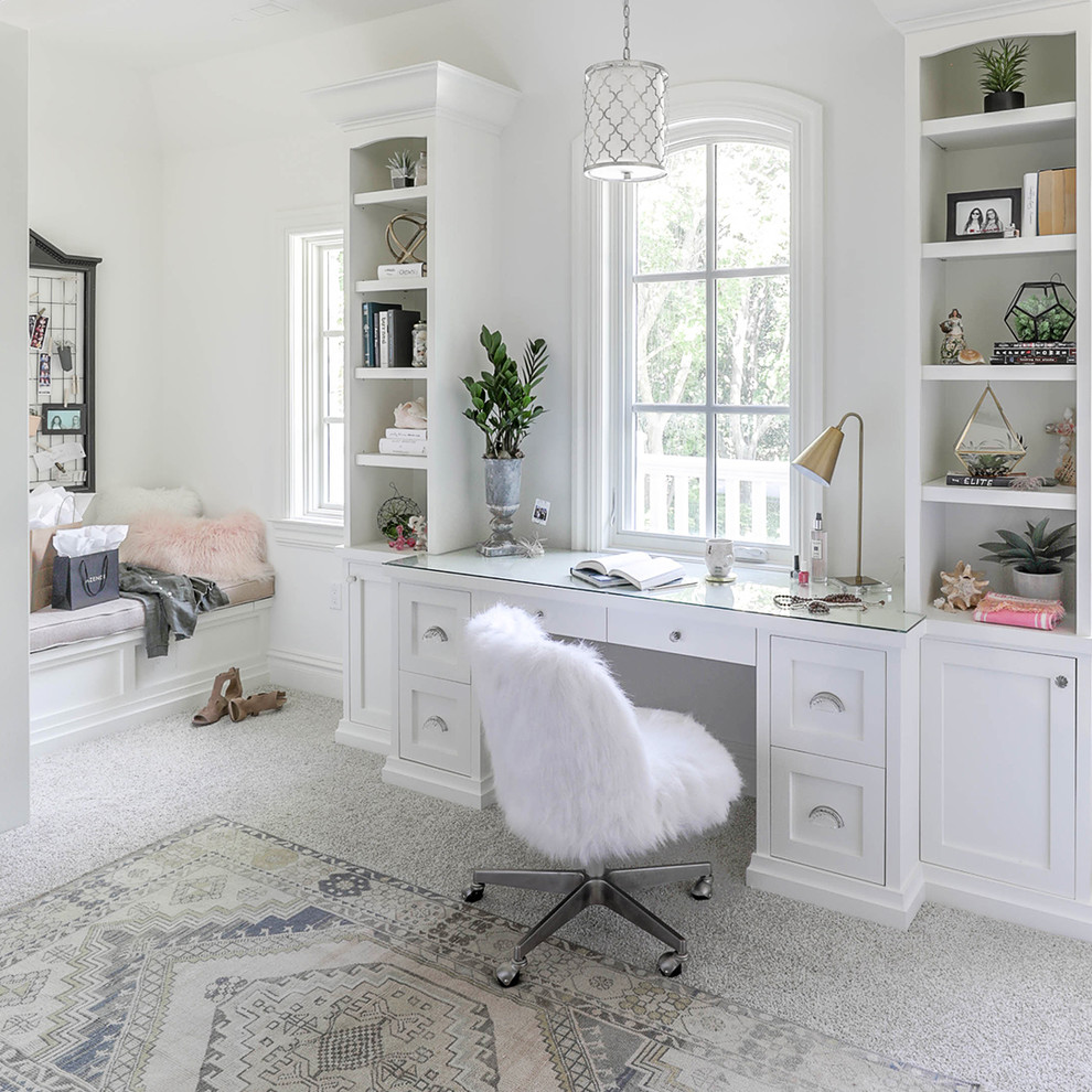 This is an example of a large transitional home office in Chicago with white walls, carpet, a built-in desk and grey floor.