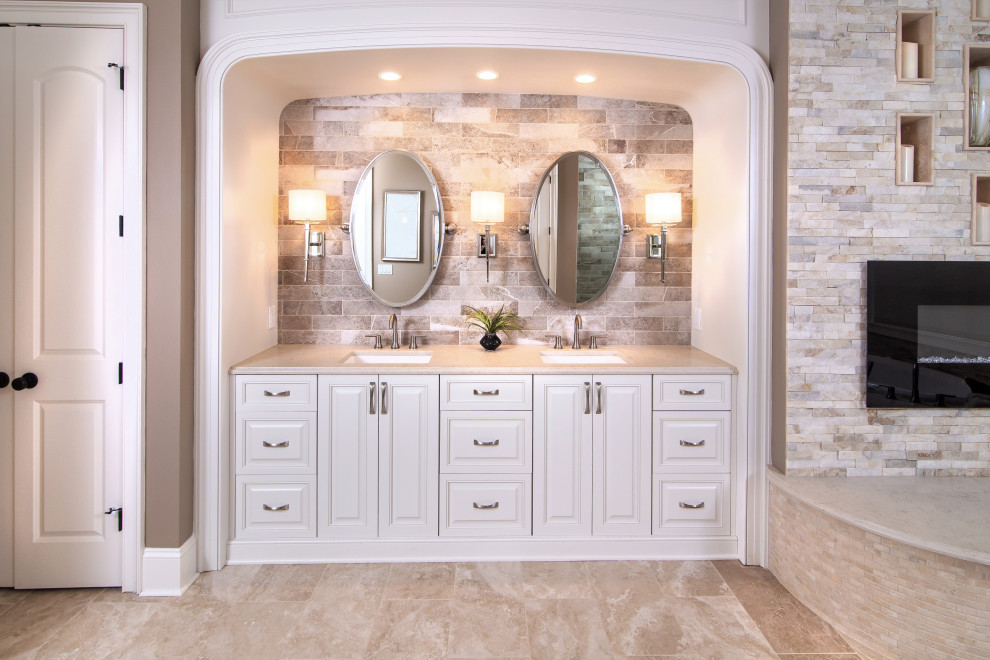 Design ideas for an expansive master bathroom in Charlotte with beige cabinets, a drop-in tub, a corner shower, multi-coloured tile, stone tile, beige walls, ceramic floors, an undermount sink, granite benchtops, beige floor, a hinged shower door, beige benchtops, a niche and a double vanity.