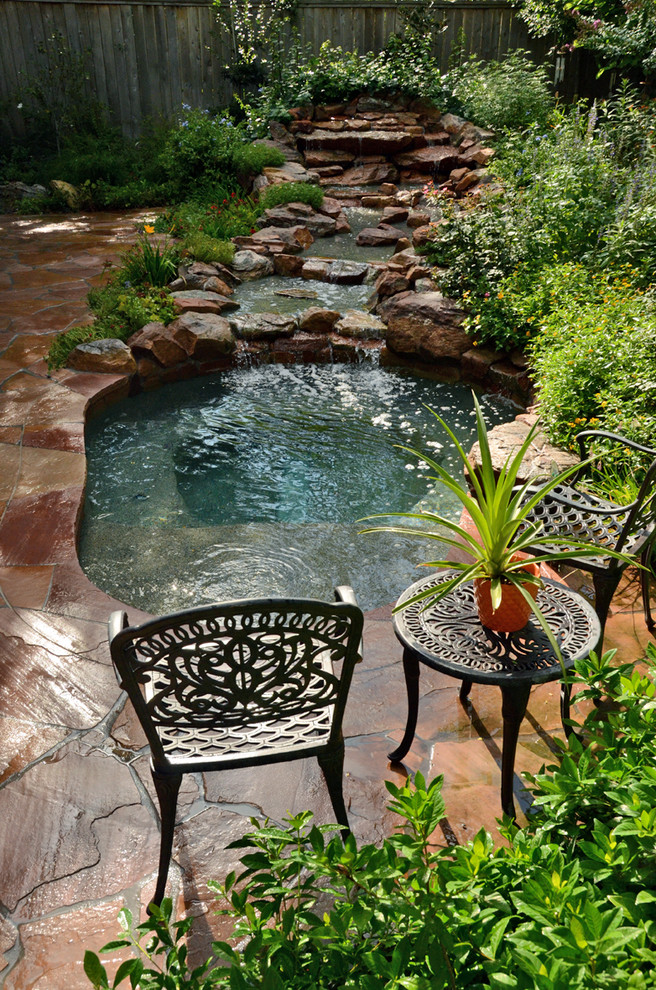 Inspiration for a small country backyard custom-shaped pool in Houston with a hot tub and natural stone pavers.