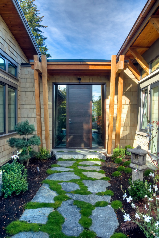 Contemporary entryway in Vancouver with a single front door and a dark wood front door.