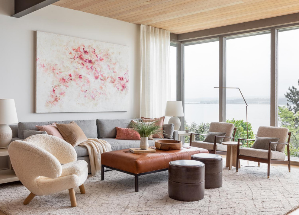 Midcentury living room in Seattle with white walls, beige floor and wood.