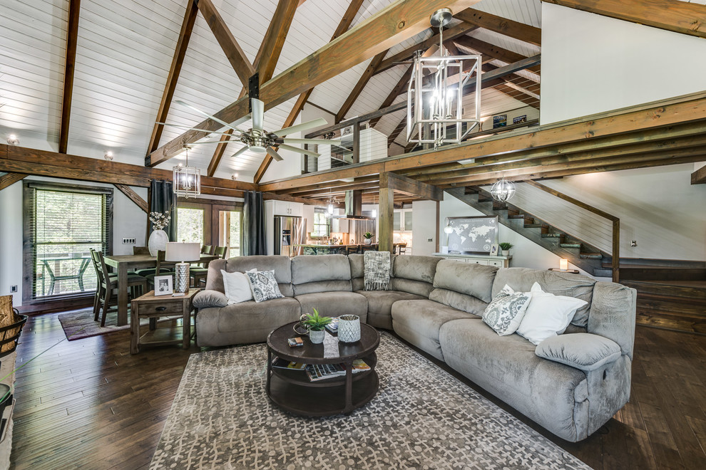 Example of a cottage open concept dark wood floor and brown floor living room design in Nashville with white walls
