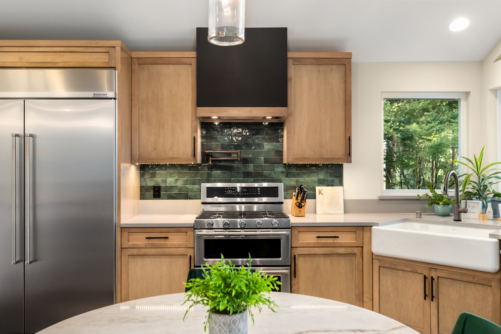 Example of an urban u-shaped dark wood floor eat-in kitchen design in Seattle with a farmhouse sink, light wood cabinets, quartzite countertops, green backsplash, stainless steel appliances, no island and gray countertops
