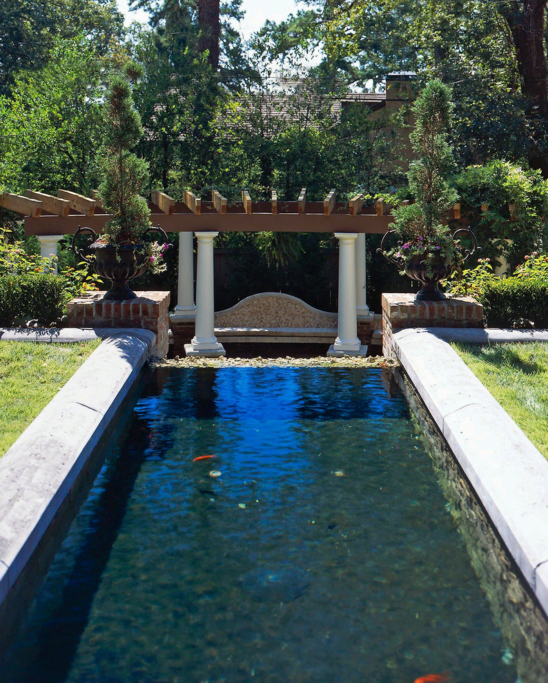 Inspiration for a mediterranean garden in Little Rock with a water feature.