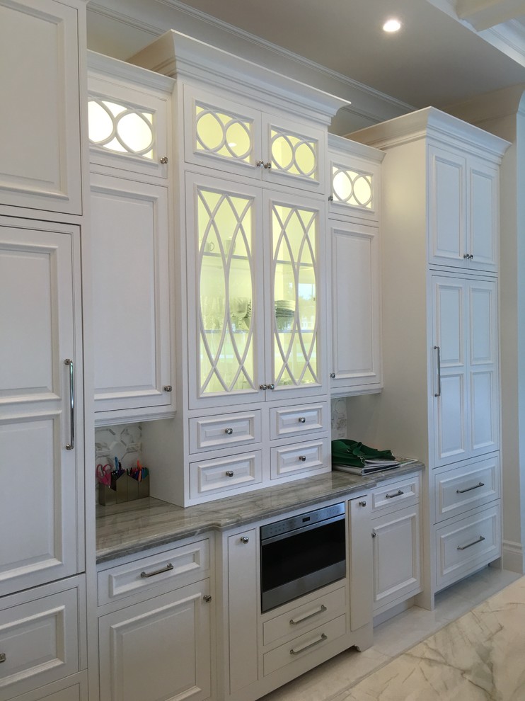 Large transitional u-shaped marble floor and white floor eat-in kitchen photo in Miami with an undermount sink, recessed-panel cabinets, white cabinets, marble countertops, gray backsplash, stone tile backsplash, paneled appliances and an island
