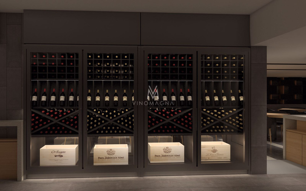 Large trendy light wood floor and brown floor wine cellar photo in London with display racks