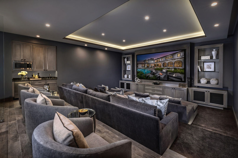 Mediterranean enclosed home theatre in Orange County with grey walls, carpet, a projector screen and brown floor.