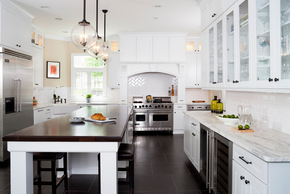 Design ideas for a large transitional eat-in kitchen in DC Metro with shaker cabinets, white cabinets, with island, a farmhouse sink, white splashback, stainless steel appliances, marble benchtops, ceramic splashback and porcelain floors.