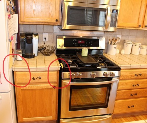 space / overhang between countertop and stove / fridge