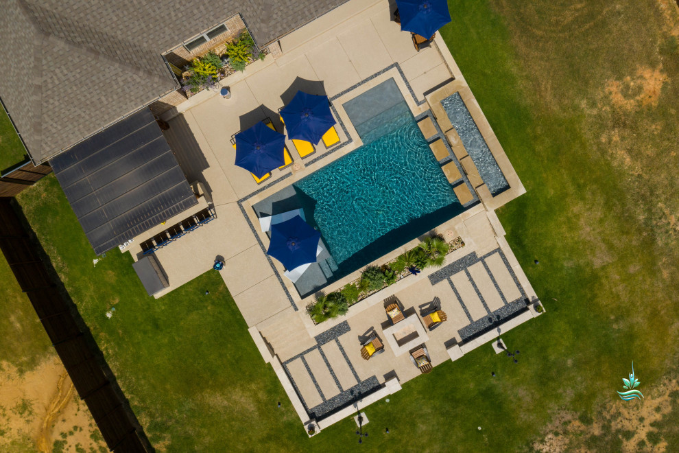 Example of a huge tuscan backyard custom-shaped infinity pool landscaping design in Dallas with decking