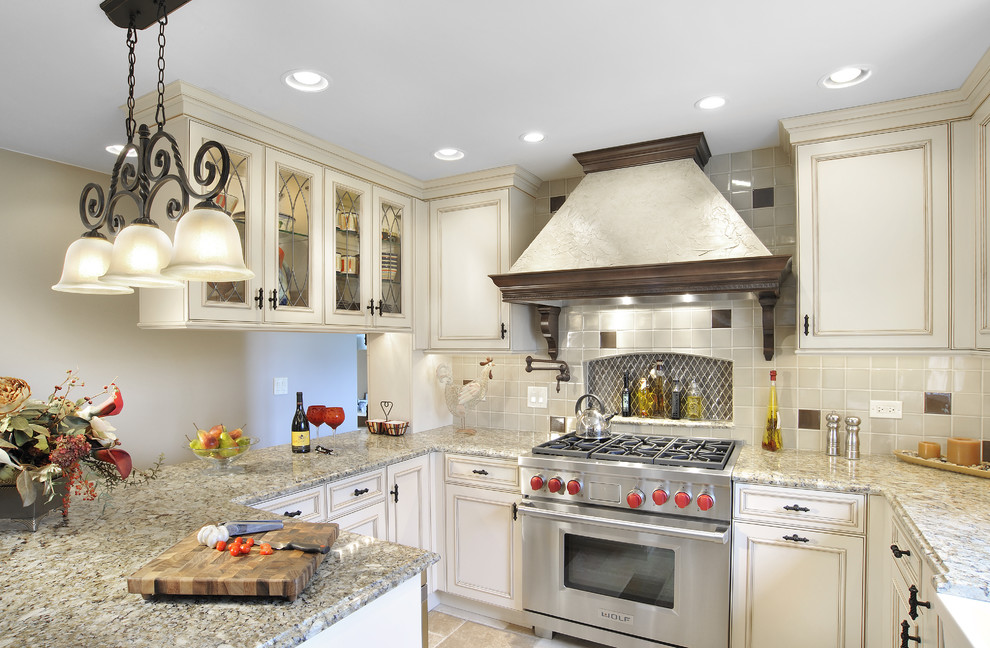 Inspiration for a traditional kitchen in Miami with glass-front cabinets and stainless steel appliances.